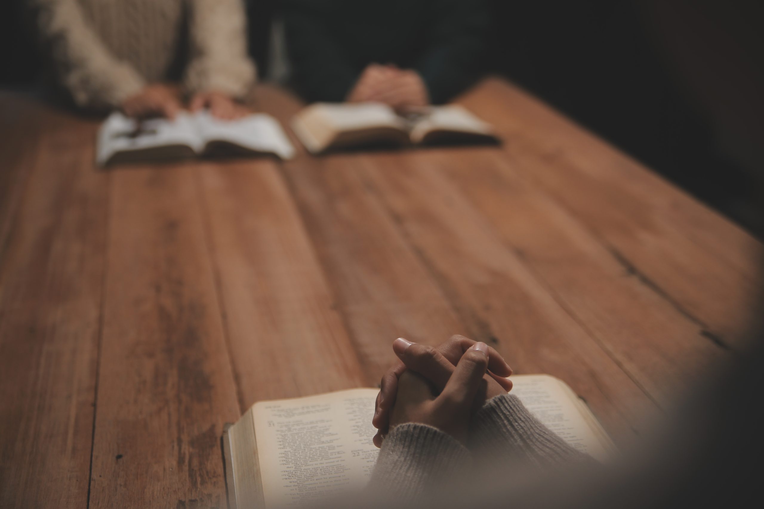 Christian group are praying to god with the bible and sharing the gospel. Concept of faith for god.